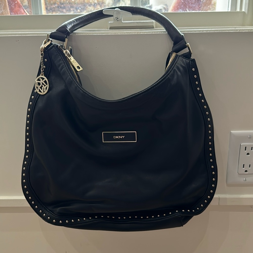 Like New DKNY black with gold studs hobo bag style bag.